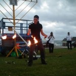 Swinging fire poi at a Chanukah party on on Bondi beach Sydney Australia