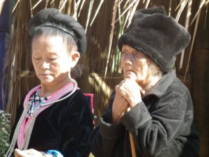 Some older Hmong women.  Notice that although they cover their hair differently, they both cover their hair.  In most tribes and communities across the world, it is customary for women to cover their hair.