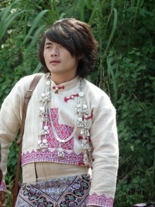 A young Hmong man in an elaborate costume. Each different village has a slightly different style of dress.